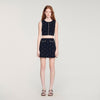 Falda corta punto bordado y strass
